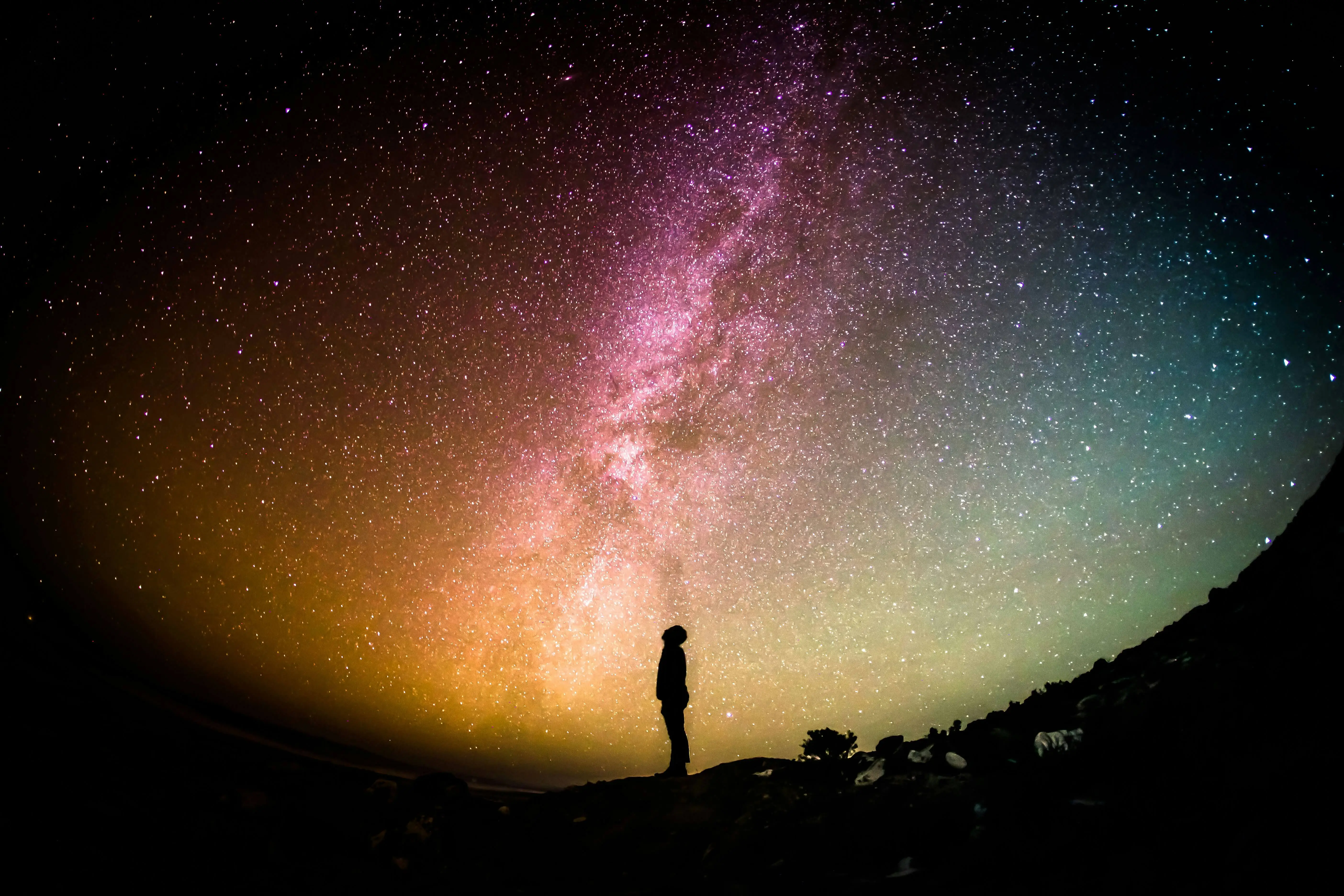 Man standing on a mountain looking into space